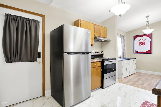 kitchen featuring hanging light fixtures, vaulted ceiling, and stainless steel appliances