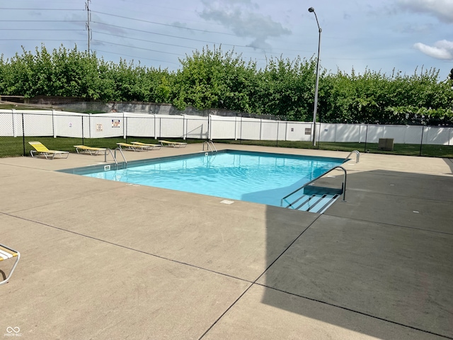 view of swimming pool with a patio