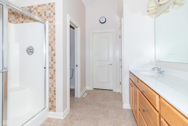 bathroom with tile patterned floors, vanity, and an enclosed shower