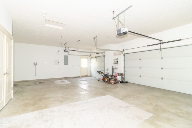 garage with a garage door opener and electric panel