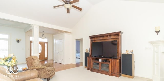 living room featuring ceiling fan, high vaulted ceiling, and decorative columns