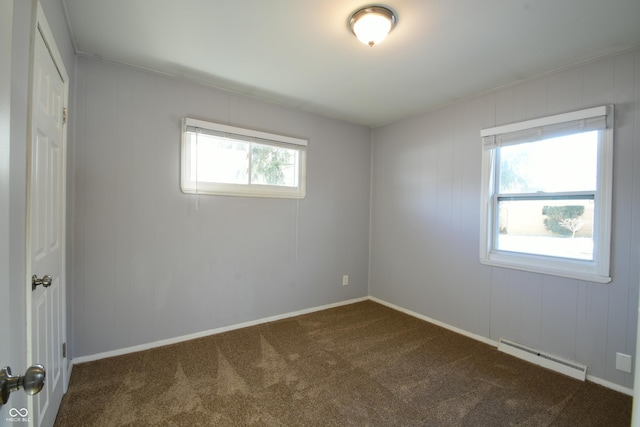 spare room featuring a baseboard radiator and carpet floors