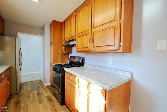 kitchen featuring stainless steel appliances and light hardwood / wood-style floors