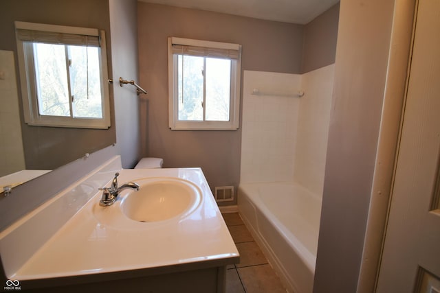 bathroom featuring vanity, tile patterned floors, and toilet