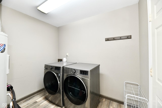 laundry area with washing machine and dryer and hardwood / wood-style floors