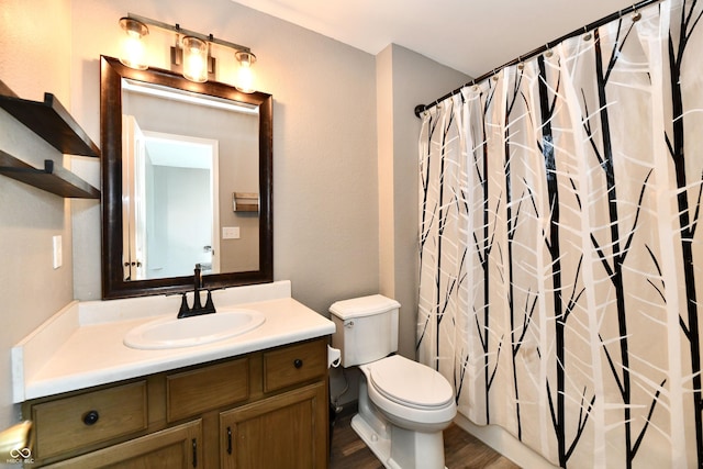 bathroom featuring vanity, hardwood / wood-style floors, a shower with shower curtain, and toilet