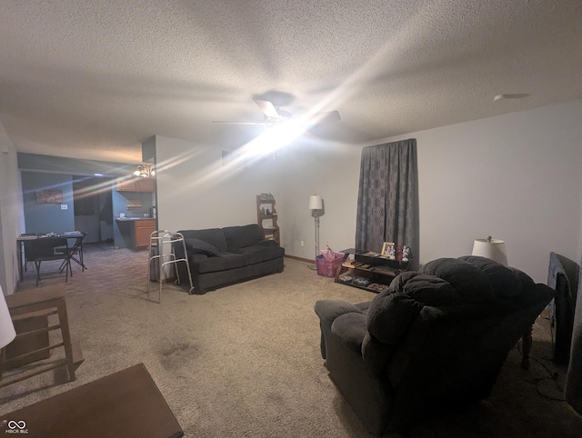 carpeted living room featuring a textured ceiling and ceiling fan