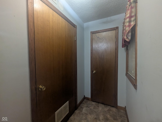 doorway with a textured ceiling