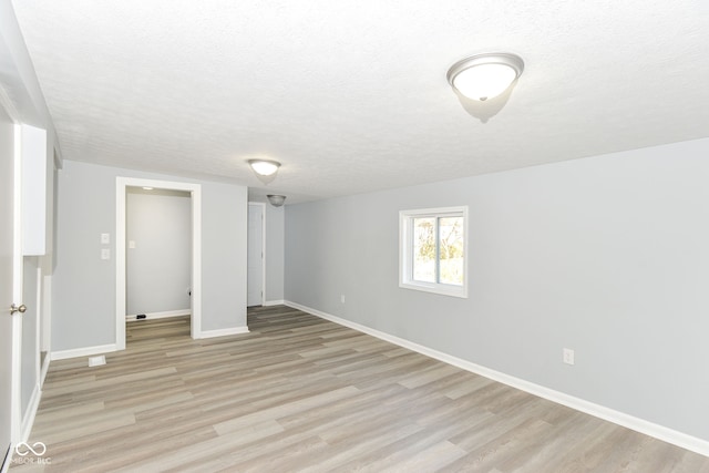 unfurnished bedroom with light hardwood / wood-style floors and a textured ceiling