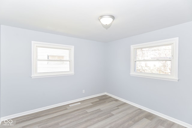 empty room with light hardwood / wood-style floors