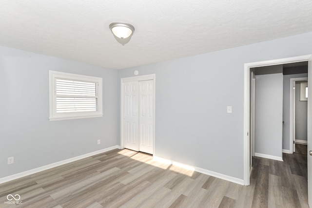 spare room with wood-type flooring and a textured ceiling