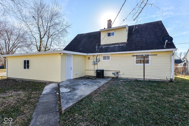 rear view of house featuring a patio and a yard