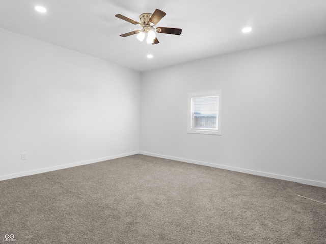 carpeted spare room with ceiling fan