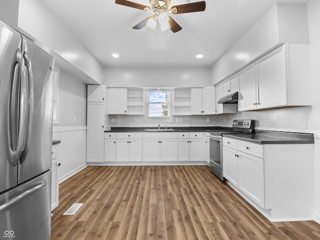 kitchen with white cabinetry, ceiling fan, appliances with stainless steel finishes, and wood-type flooring