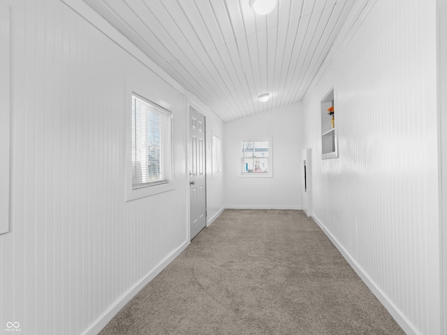 hallway featuring light carpet and lofted ceiling