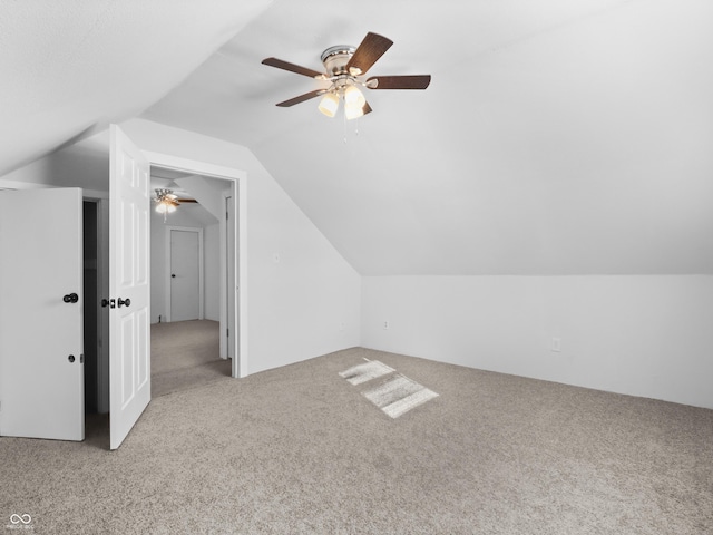 additional living space with light colored carpet and lofted ceiling