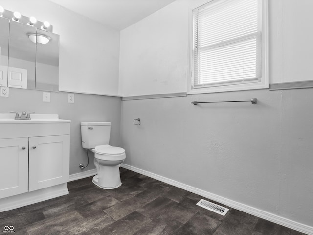 bathroom with vanity, hardwood / wood-style floors, and toilet