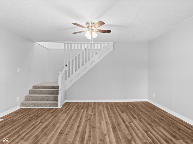 interior space featuring hardwood / wood-style floors, a textured ceiling, and ceiling fan