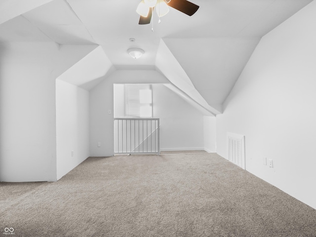 bonus room featuring lofted ceiling, carpet flooring, and ceiling fan