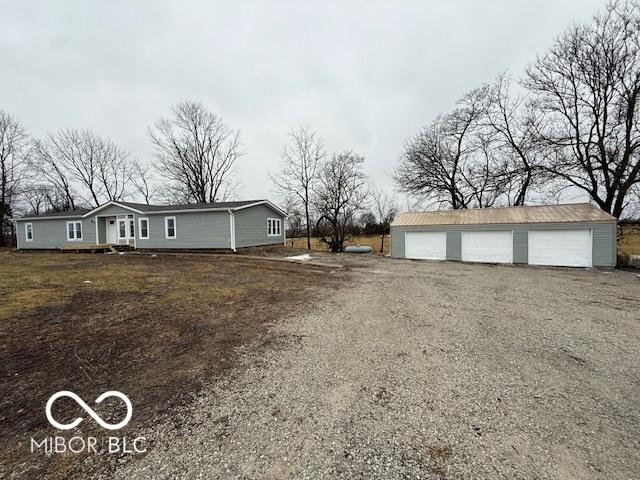 view of front of house with a garage and an outdoor structure