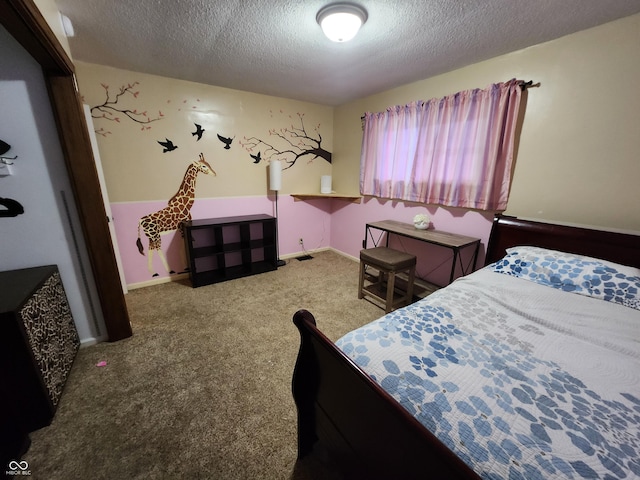 carpeted bedroom featuring a textured ceiling