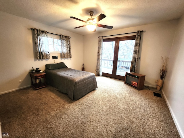 bedroom featuring ceiling fan, carpet floors, access to exterior, and a textured ceiling