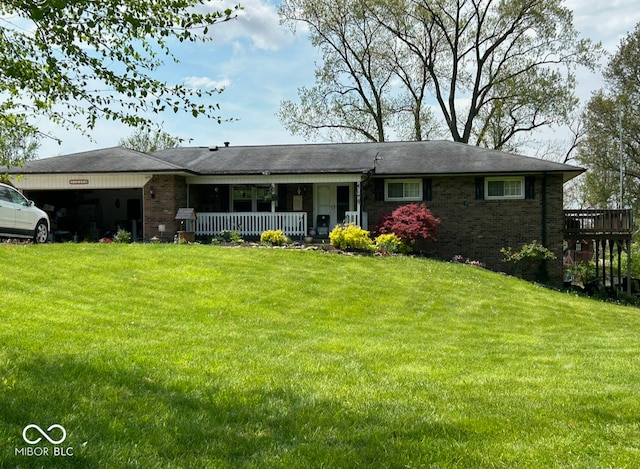 view of front of home featuring a garage, a porch, and a front lawn