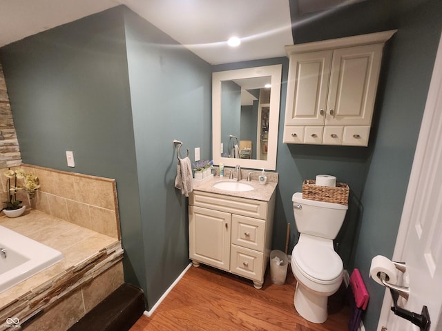 bathroom featuring vanity, toilet, and hardwood / wood-style floors