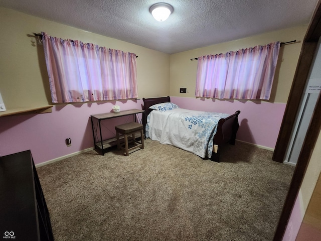 bedroom featuring a textured ceiling and carpet