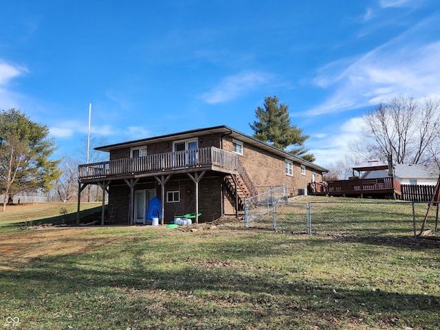 back of property with a yard and a deck