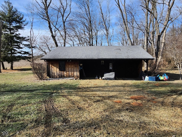 view of outbuilding with a yard