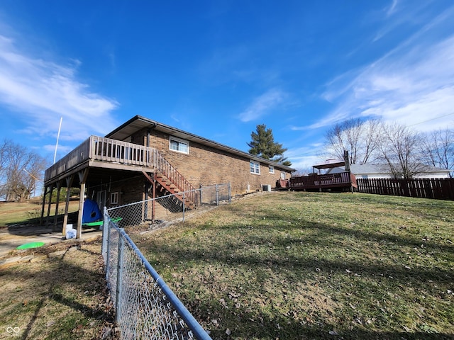 exterior space with a wooden deck and a yard