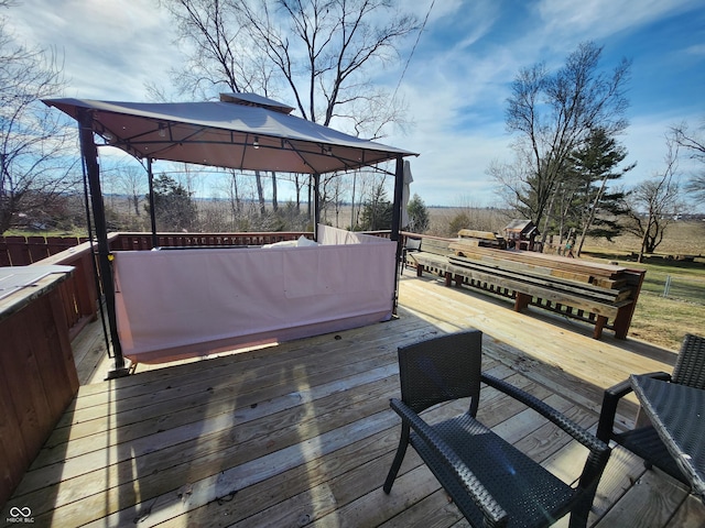 wooden terrace featuring a gazebo