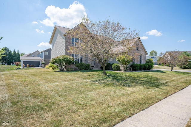 view of front of property featuring a garage and a front lawn