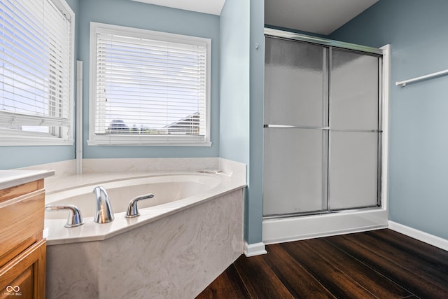 bathroom featuring shower with separate bathtub, hardwood / wood-style floors, and vanity