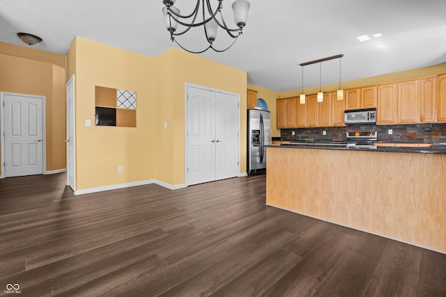 kitchen featuring backsplash, stainless steel appliances, dark hardwood / wood-style flooring, decorative light fixtures, and light brown cabinets