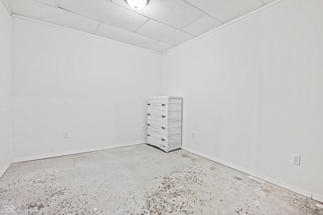 unfurnished room with a drop ceiling