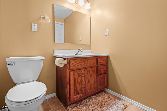 bathroom featuring tile patterned floors, vanity, and toilet