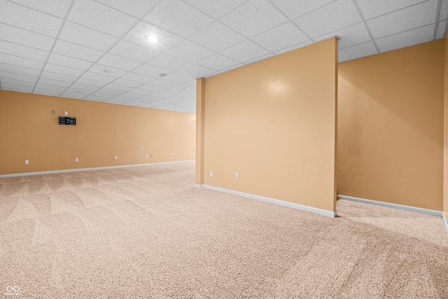 basement featuring carpet flooring and a drop ceiling