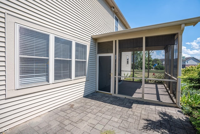 view of exterior entry featuring a patio