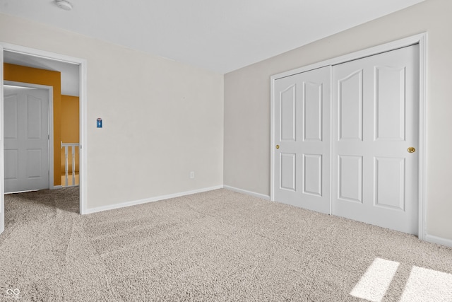 unfurnished bedroom with carpet floors and a closet