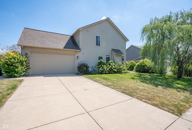 view of front facade with a garage and a front lawn