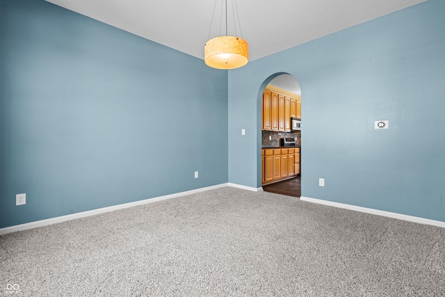 empty room featuring dark colored carpet