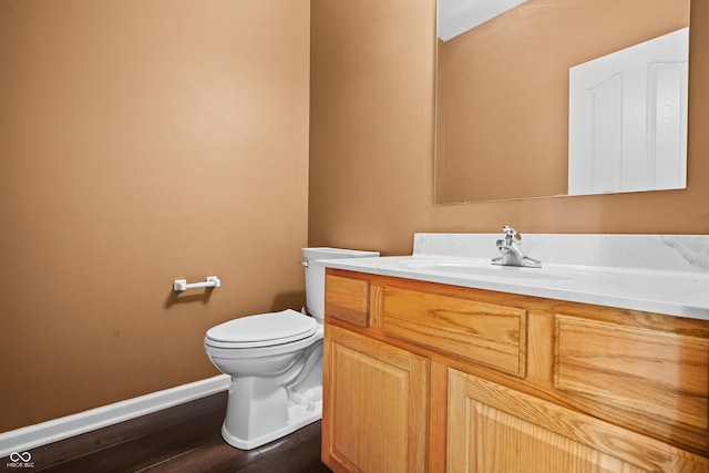 bathroom featuring vanity, hardwood / wood-style floors, and toilet