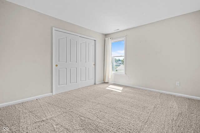 unfurnished bedroom with carpet floors and a closet