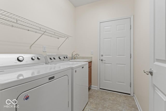 laundry room with separate washer and dryer, sink, light tile patterned floors, and cabinets