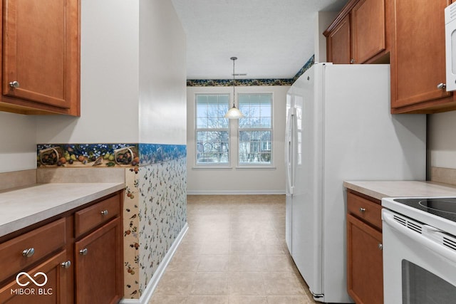 kitchen with pendant lighting and white appliances