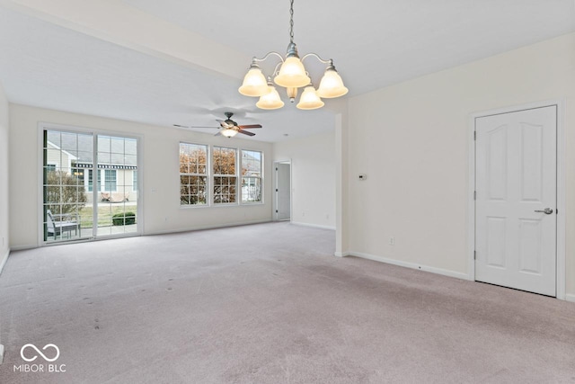 carpeted spare room with ceiling fan with notable chandelier