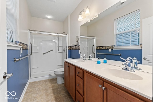 bathroom with an enclosed shower, vanity, tile patterned floors, and toilet