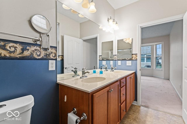 bathroom with tile patterned floors, vanity, and toilet